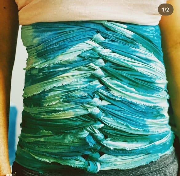 Benkung belly binding wrapped in teal and green fabric
