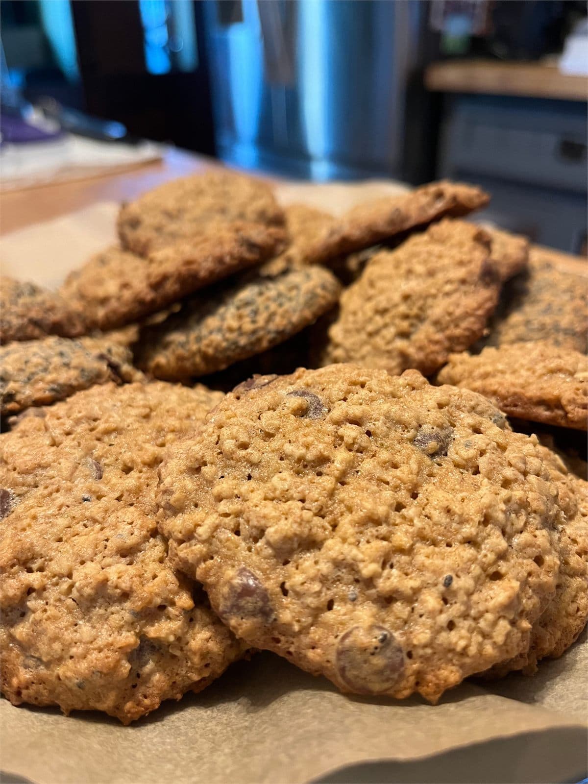 Freshly baked oatmeal chocolate chip lactation cookies cooling on parchment